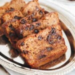 Sliced almond flour banana bread on a silver tray.