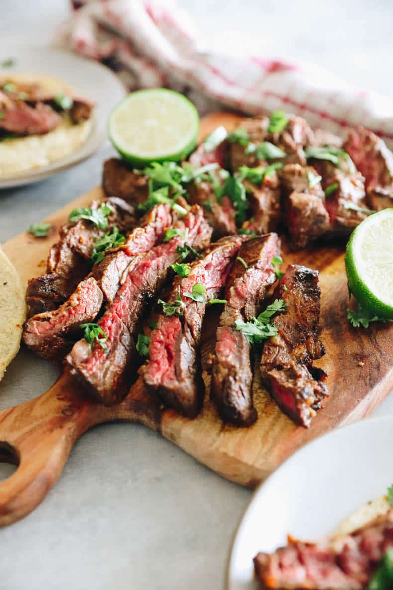 Sliced skirt steak on a cutting board.