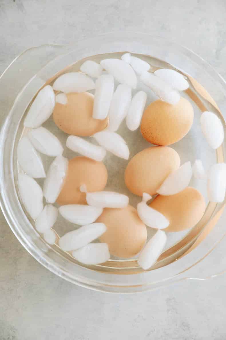 hard boiled eggs cooling in an egg bath.