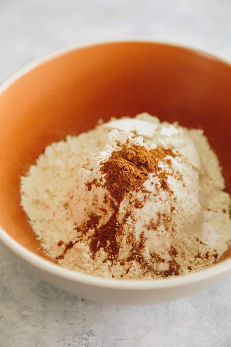 Dry ingredients mixed in a bowl for zucchini muffins.