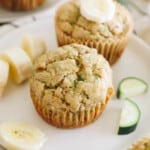 banana zucchini muffins on a white plate.