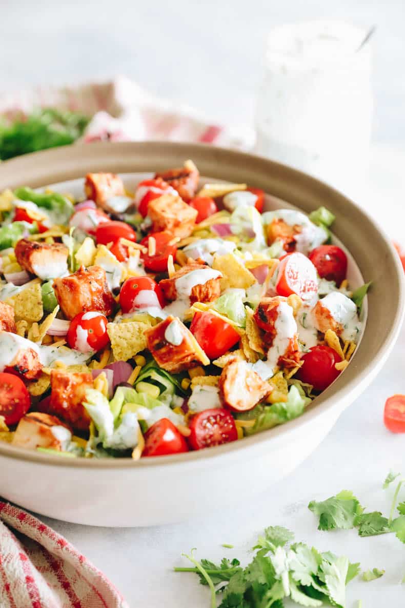 overhead image of BBQ chicken salad in a large serving bowl with greek yogurt ranch dressing.