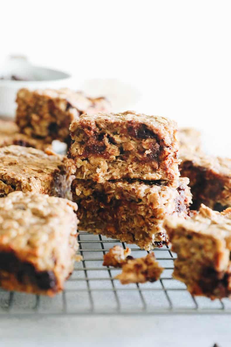 two oatmeal bars stacked on top of one another on a wire rack.