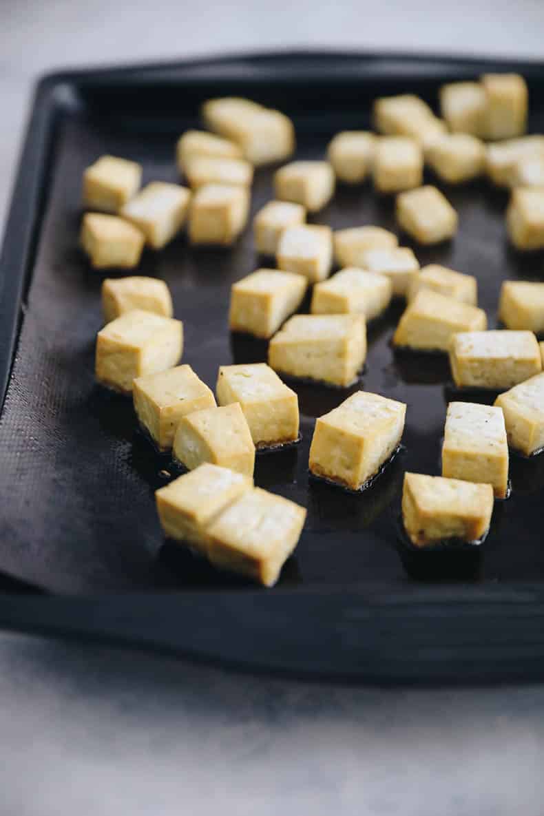 roasted tofu on a baking sheet for buddha bowls