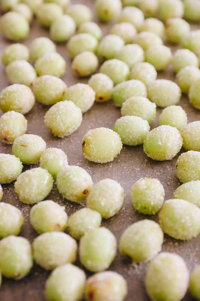 frozen candy grapes on a baking sheet.