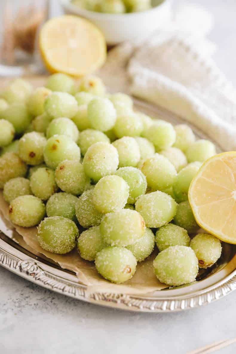 candy grapes on a silver platter.