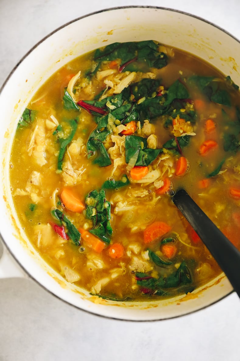 Overhead shot of chicken lentil soup in a large pot.