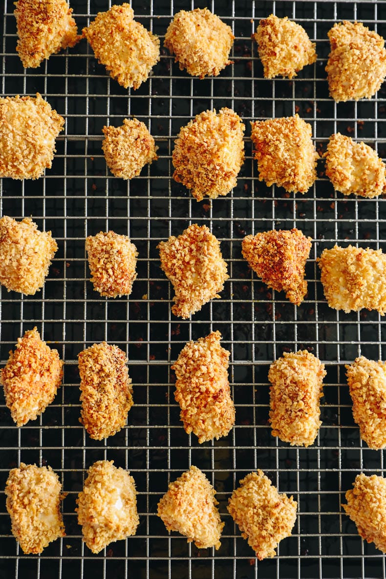 Homemade chicken nuggets on a wire rack.