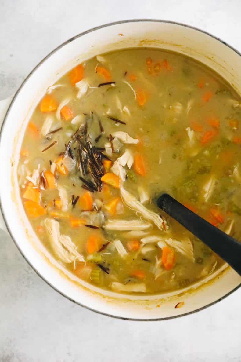 Chicken wild rice soup in a large white dutch oven.