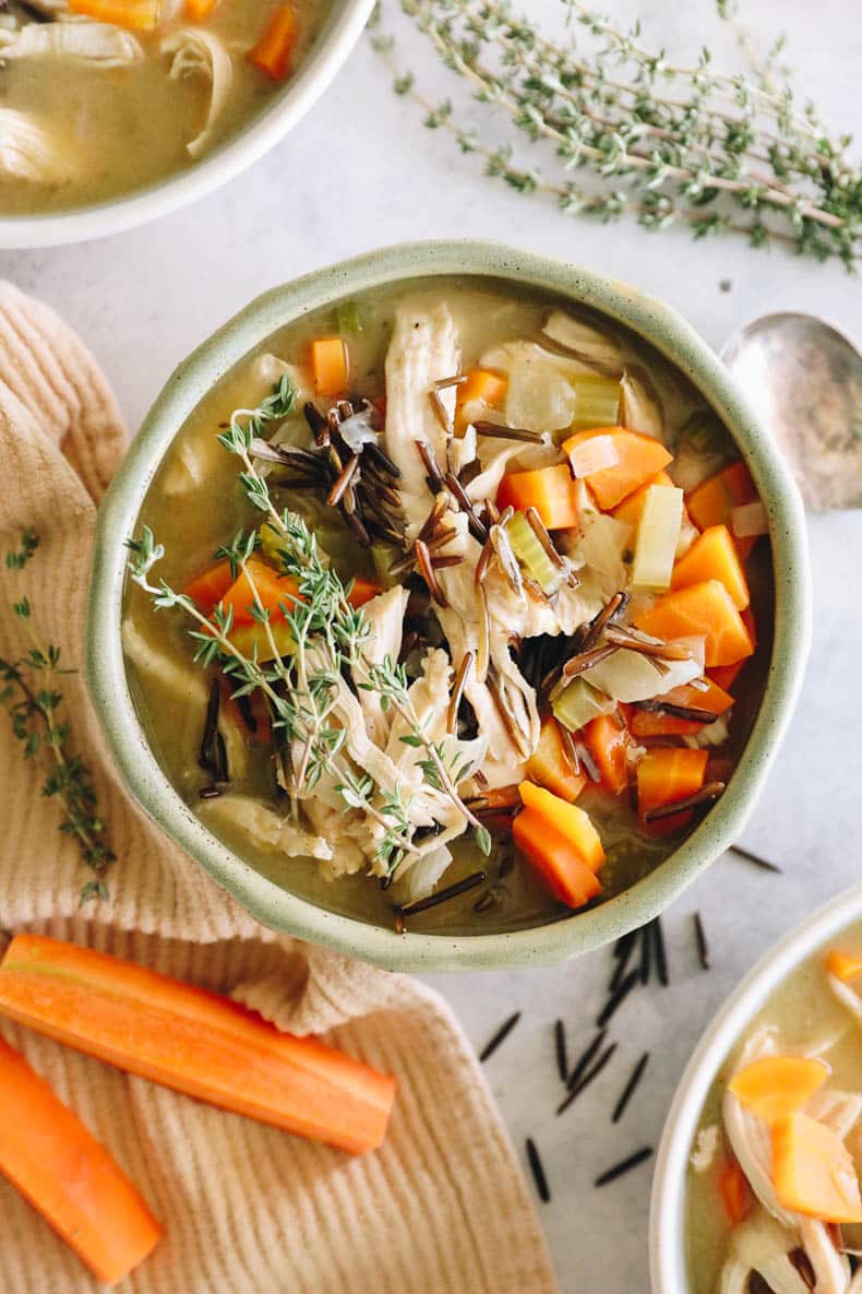 overhead image of chicken wild rice soup in a large green bowl.