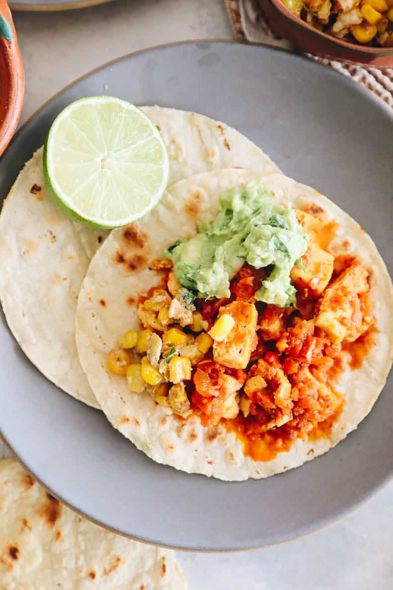 chipotle sofritas on corn tortillas with guacamole, lime + corn.