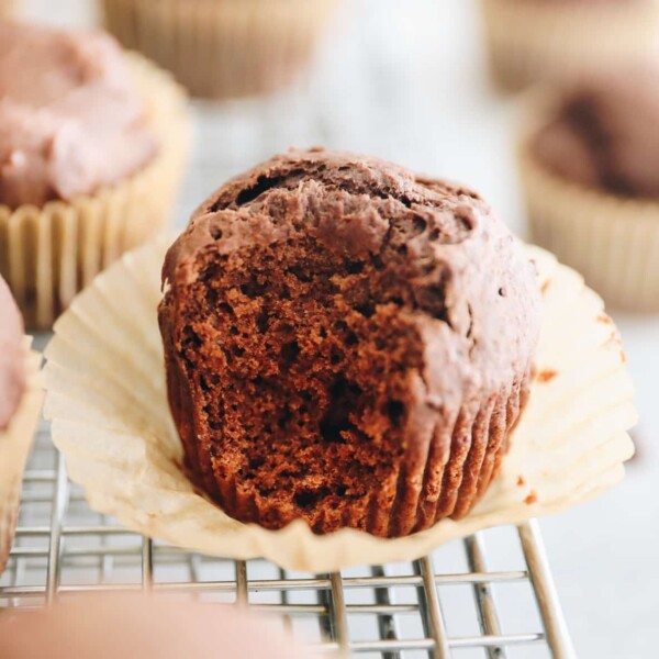 Chocolate gingerbread muffin with a bite taken out of it.