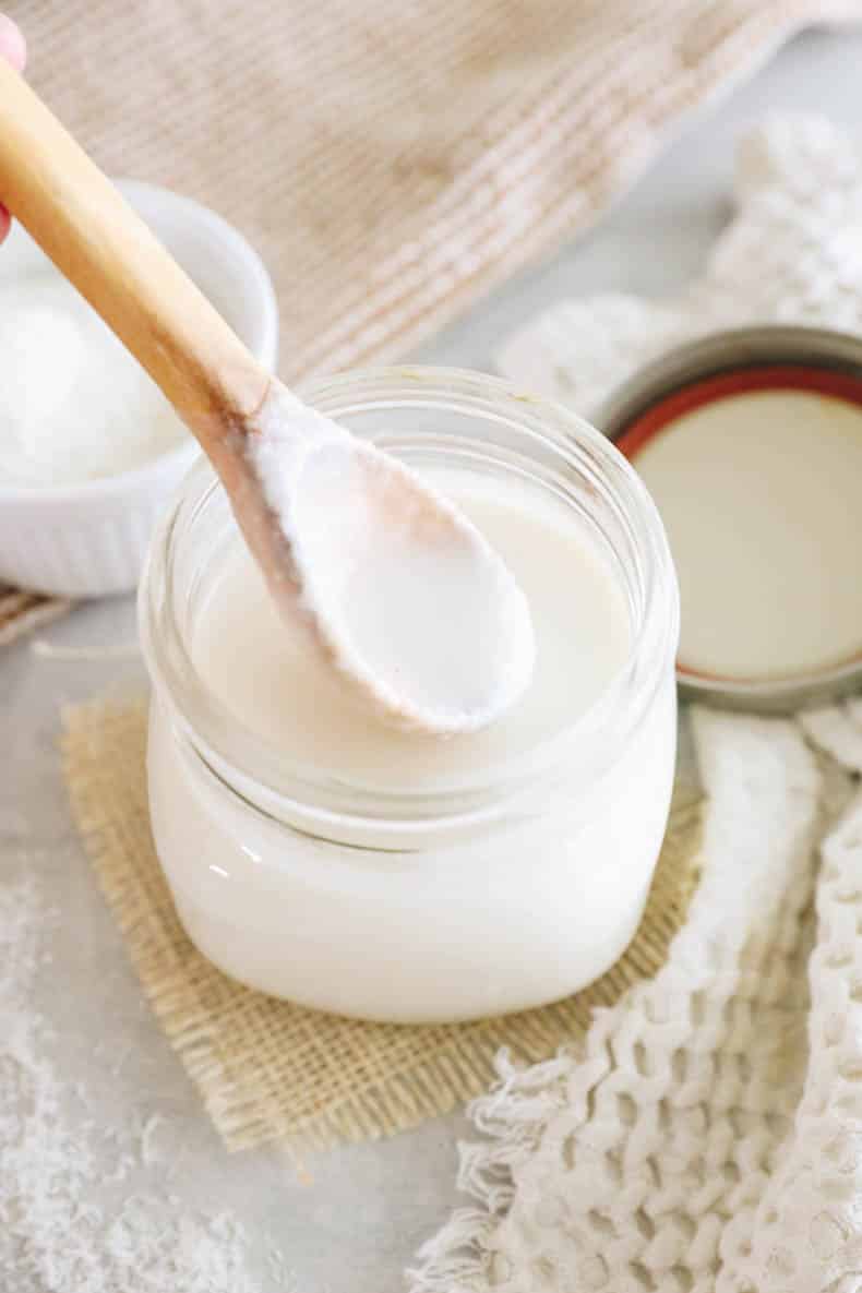 drippy coconut butter on a wooden spoon.