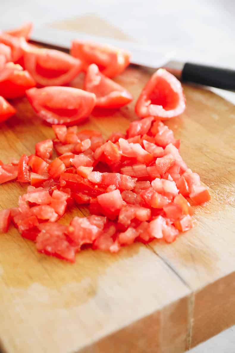 chopped tomatoes on a cutting board.