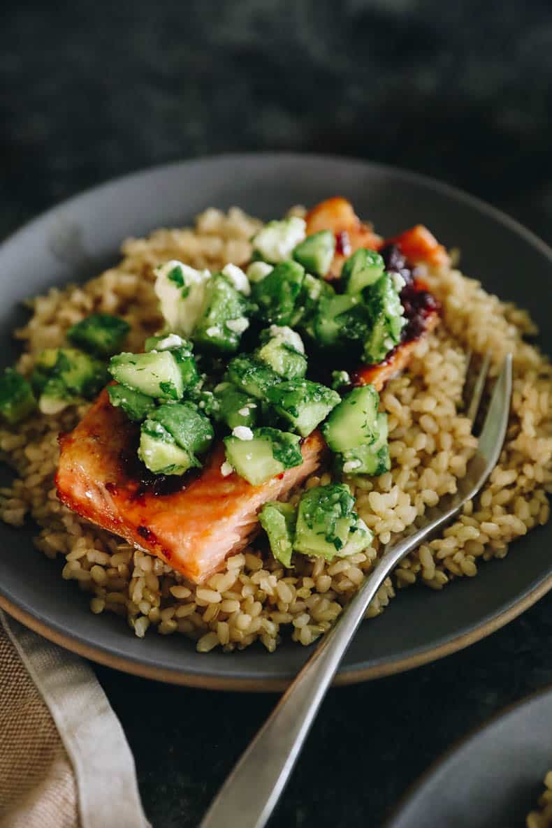 Chipotle salmon with rice and avocado cucumber salsa.