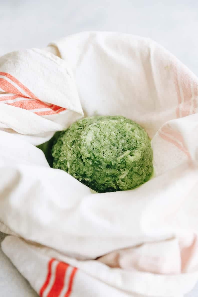 shredded zucchini in a dish towel.