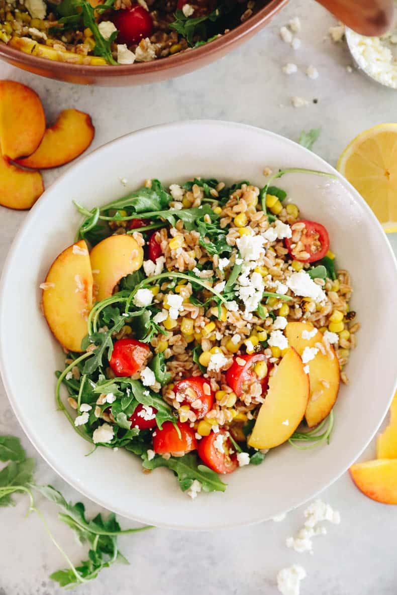 summer farro salad in a white bowl.