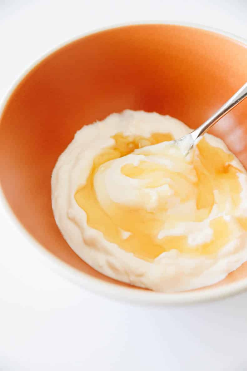 mixing homemade frozen yogurt in a bowl.