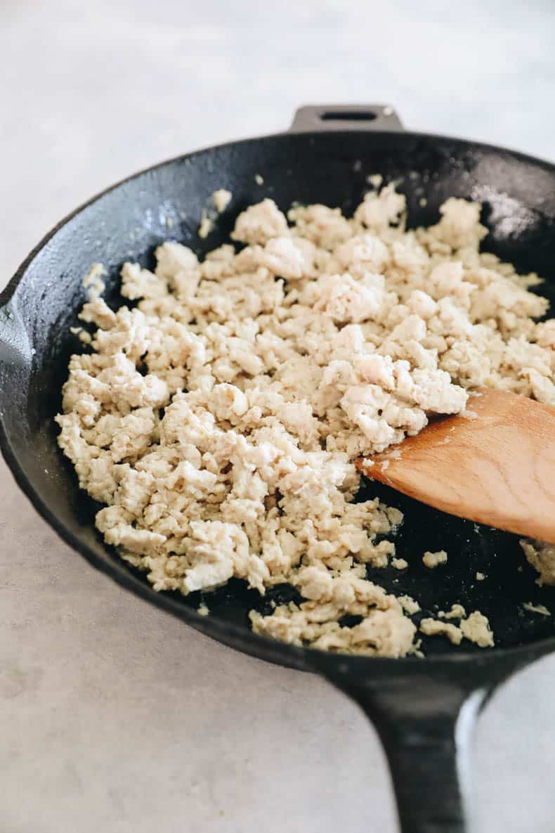 sautéed ground chicken in a cast iron skillet