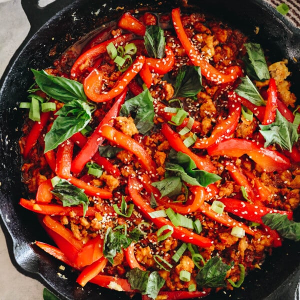 gochujang chicken bowls and veggies in a cast iron dish.