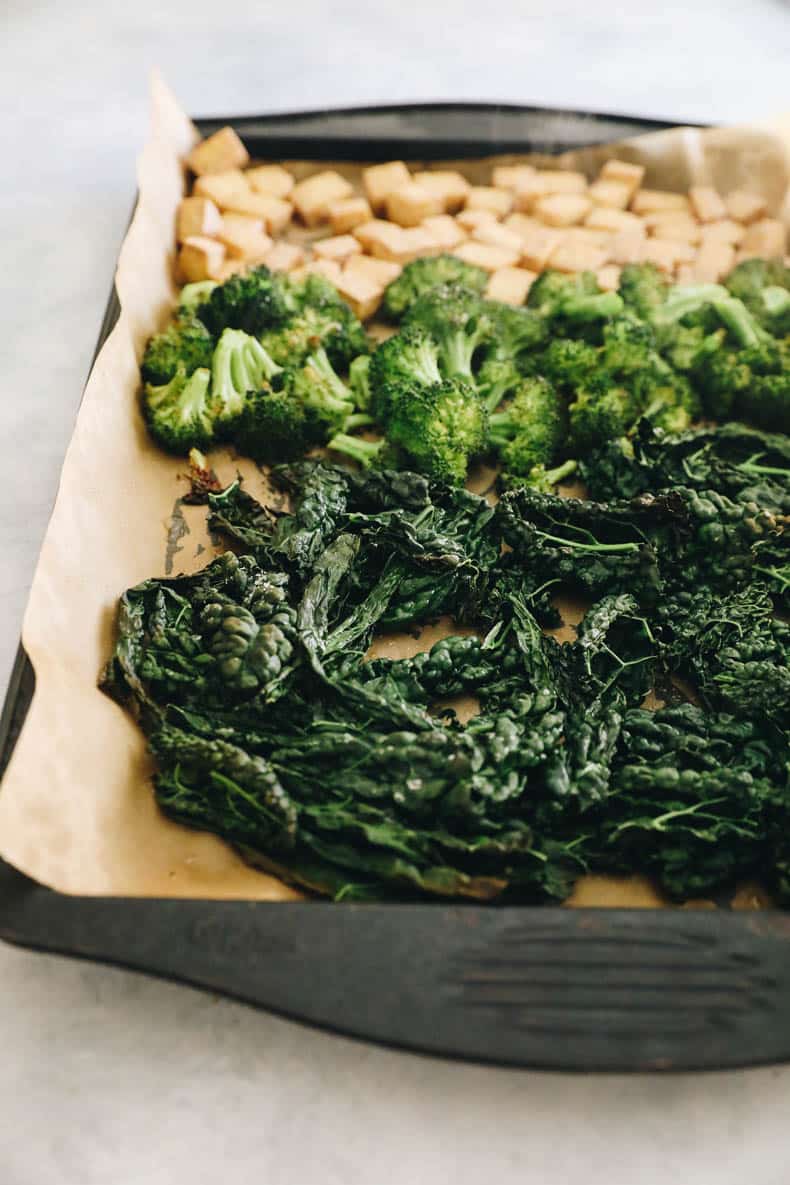 Roasted kale, broccoli and tofu on a sheet pan.