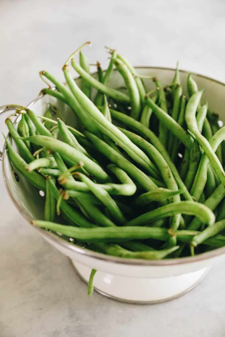 Fresh green beans in a colander.