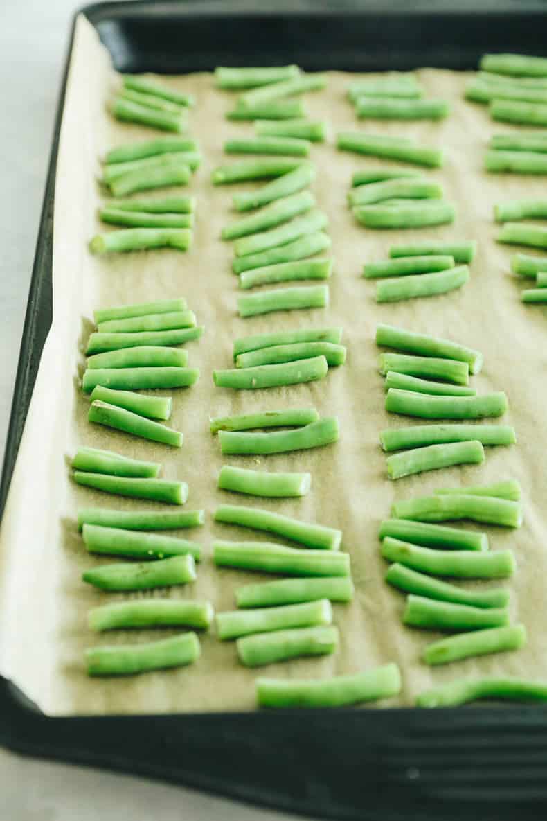 frozen green beans on a baking sheet.