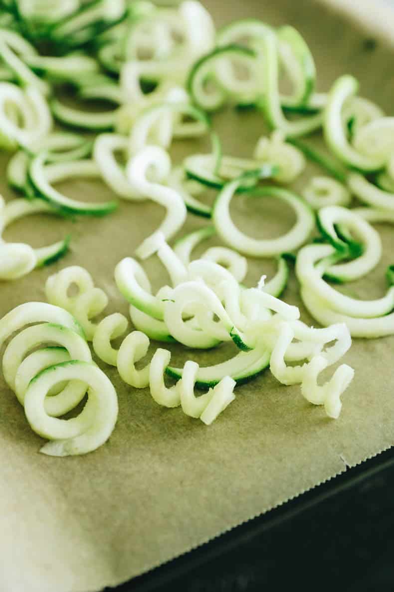 frozen zucchini noodles on a sheet pan.