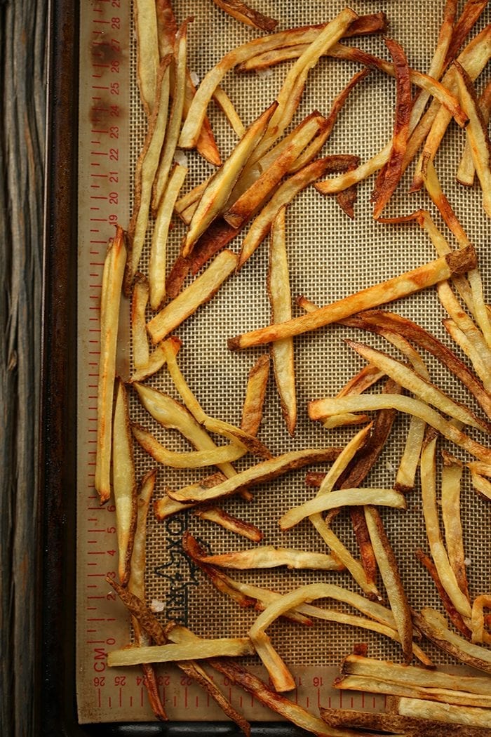 Have you ever wondered how to make crispy baked french fries without them burning? Here's my trick to the ultimate french fries recipe without going near a deep fryer!