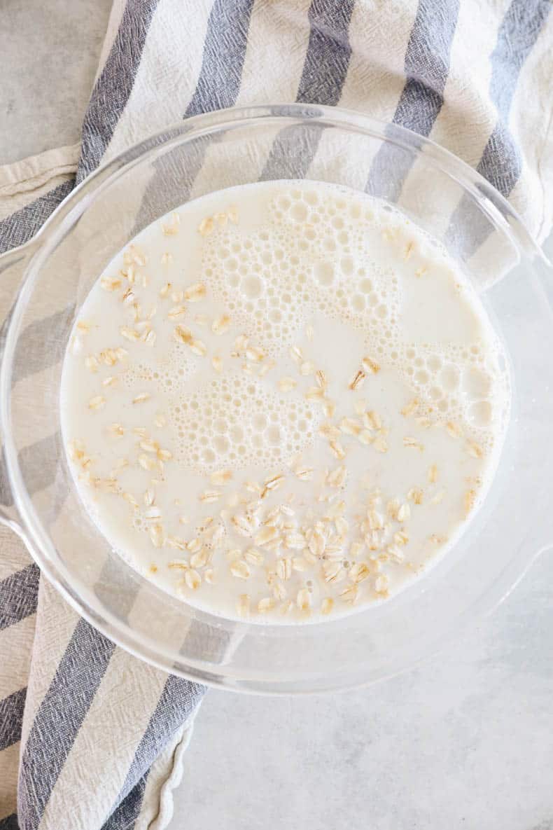 rolled oats in a glass bowl with milk