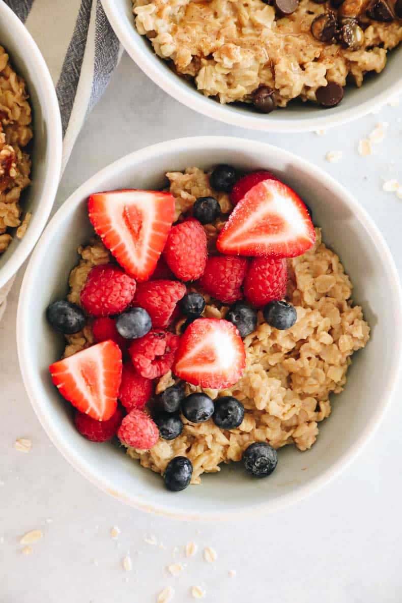 A bowl of oatmeal topped with berries.