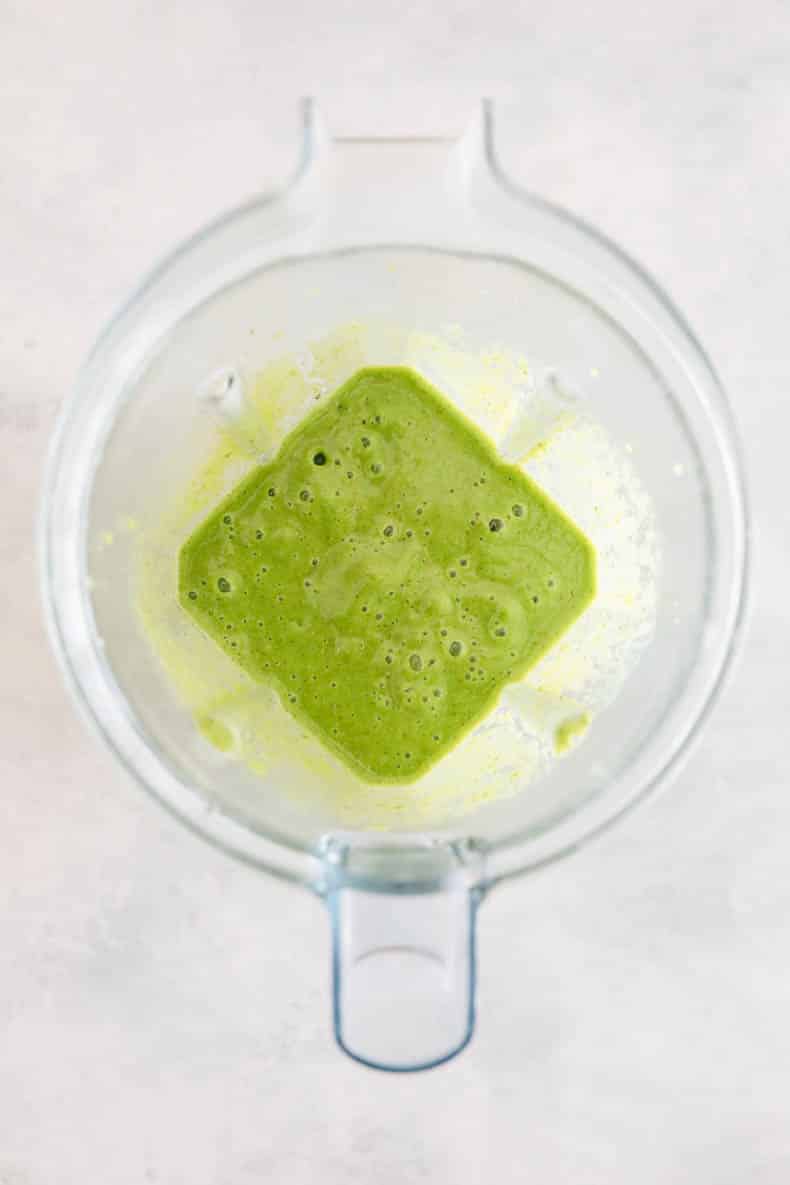 tropical kiwi smoothie blended up in a blender.