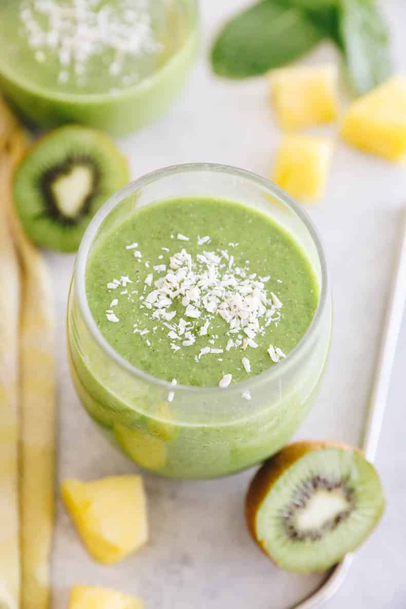 close-up of kiwi smoothie in a clear glass and sprinkled with coconut.