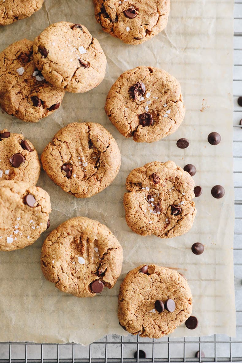 Overhead image of protein cookies on a wire rack with chocolate chips.