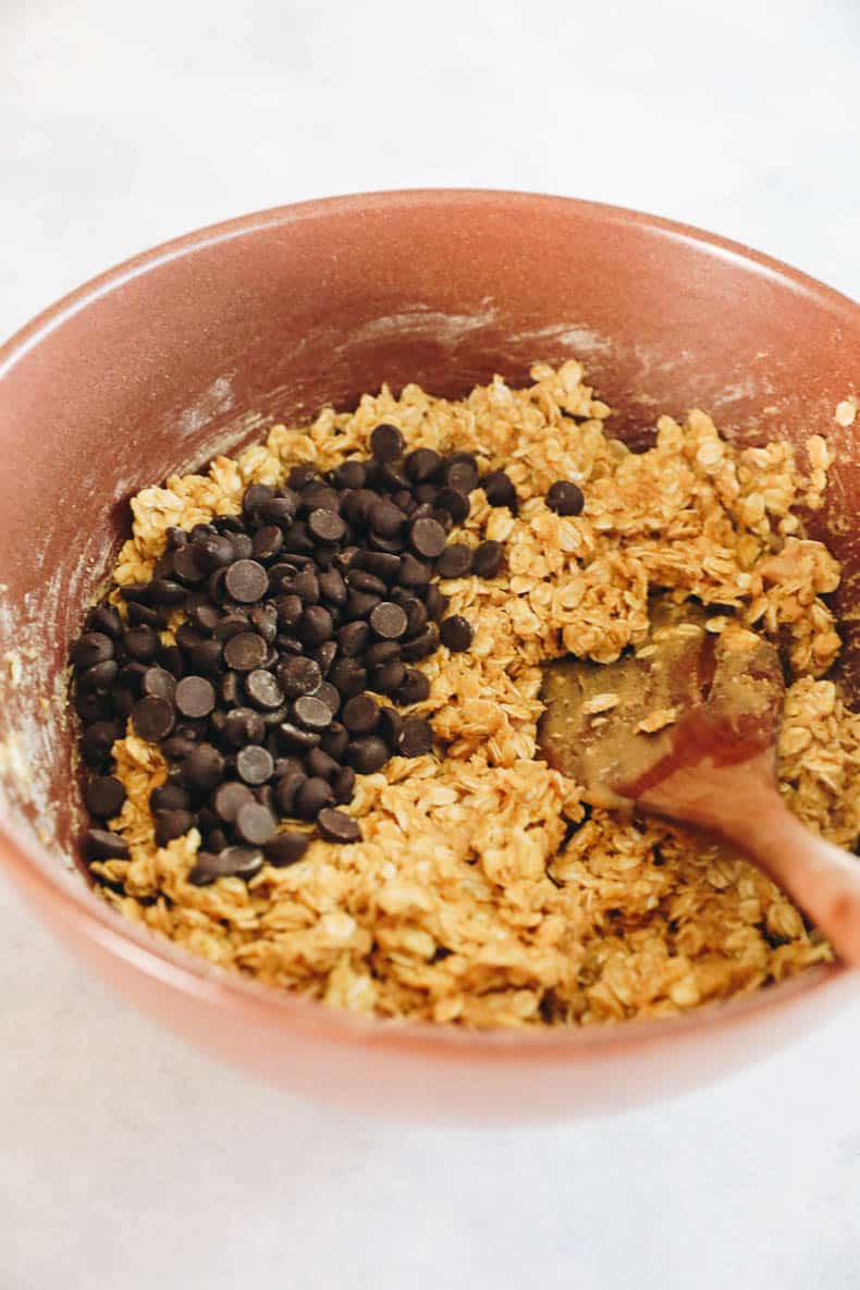 granola bar ingredients in a large brown bowl.