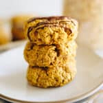 Stack of pumpkin breakfast cookies on a white plate.