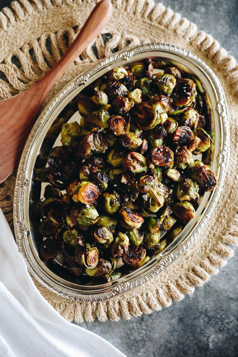 roasted balsamic brussel sprouts on a silver platter.