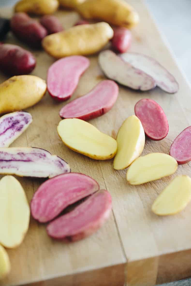 Sliced fingerling potatoes on a cutting board