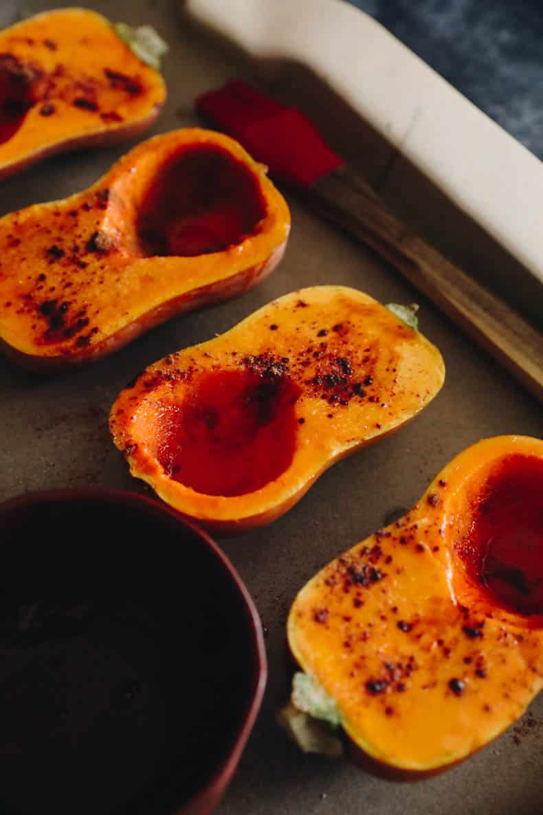 squashes on a sheet pan lined with parchment paper.