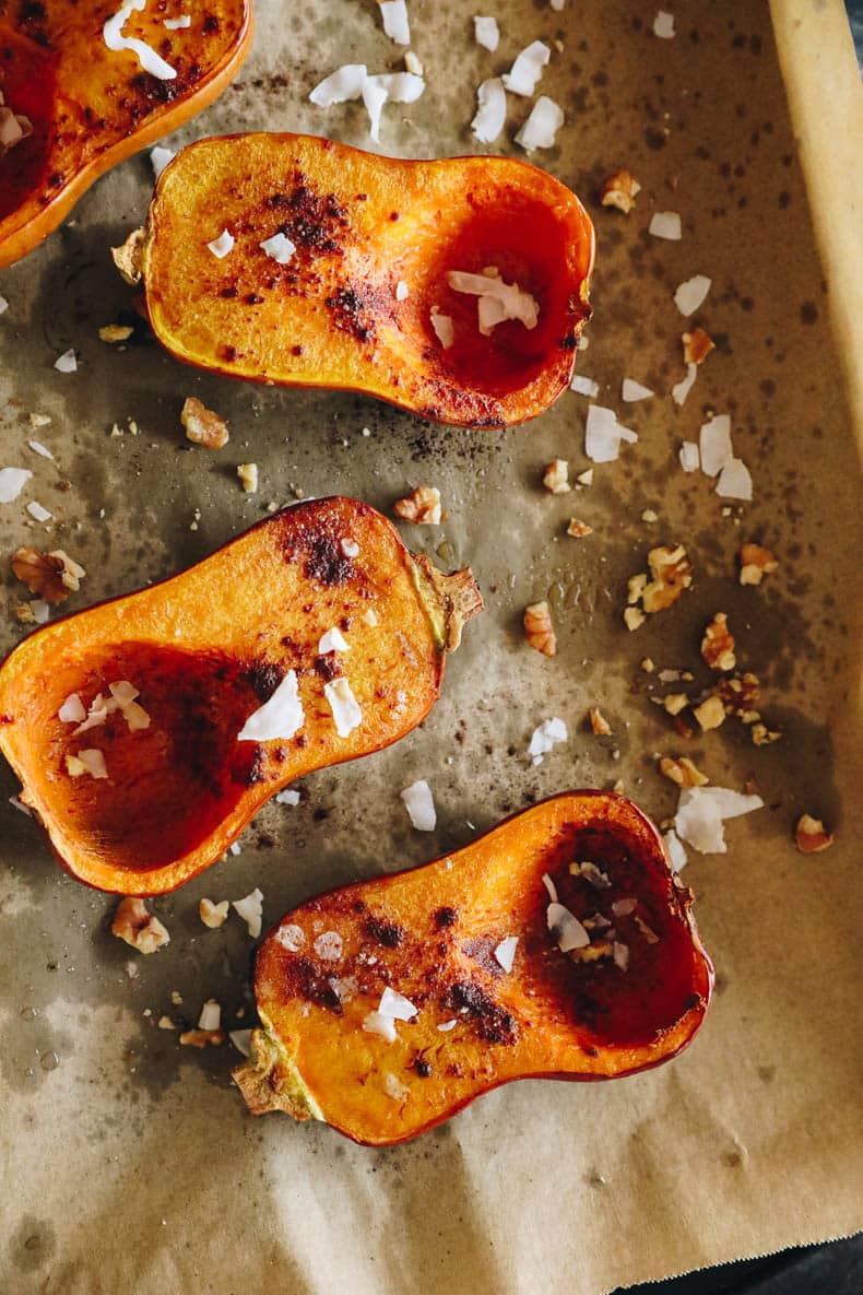 Honeynut squashes roasted on a sheet pan.