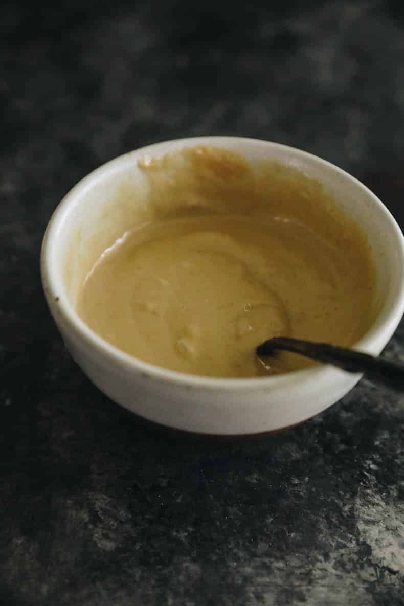 Miso tahini sauce in a small white bowl.