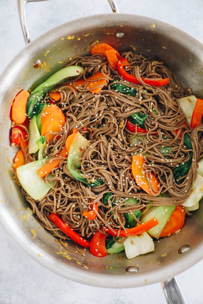 Sesame soba noodles in a large metal wok.