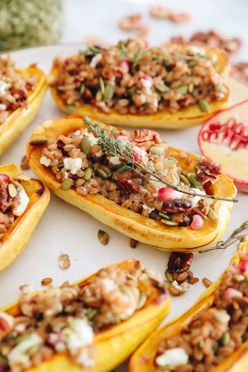 farro stuffed delicata squash on a white plate.