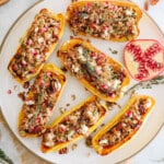 stuffed delicata squashes with farro, pomegranate seeds, pumpkin seeds, pecans and goat cheese.