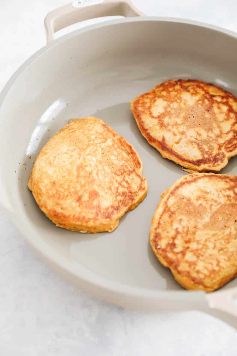 sweet potato pancakes in a skillet.