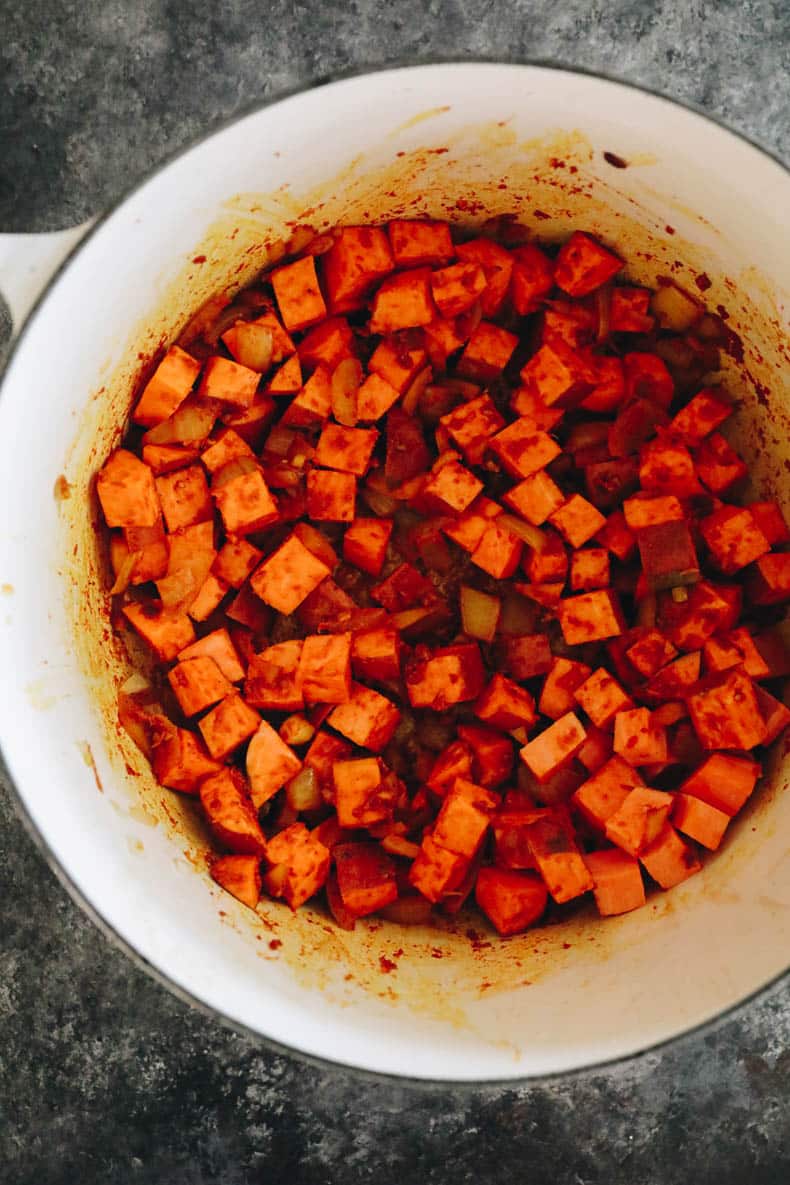 Cubed sweet potato in a stock pot.