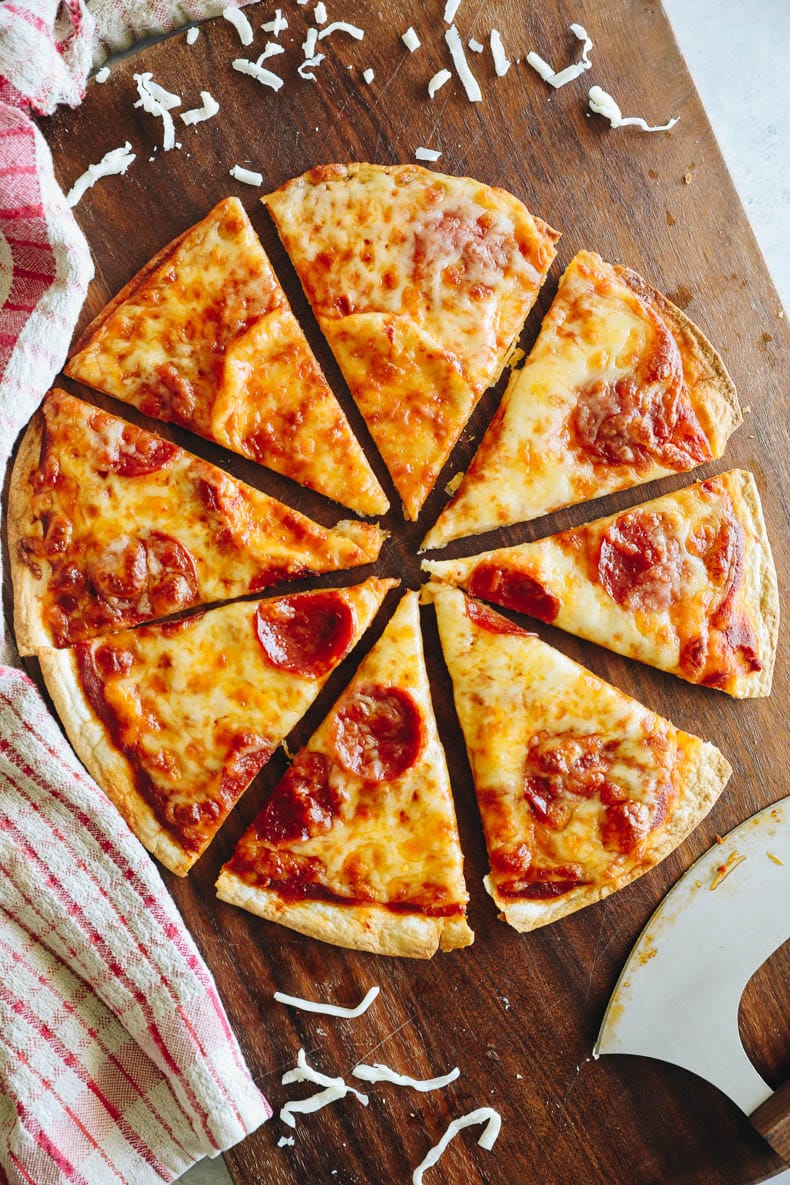 tortilla pizza on a cutting board.