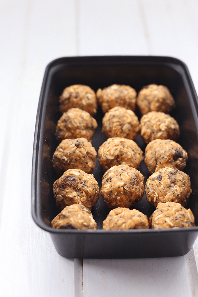 rolled protein balls in a black storage container.